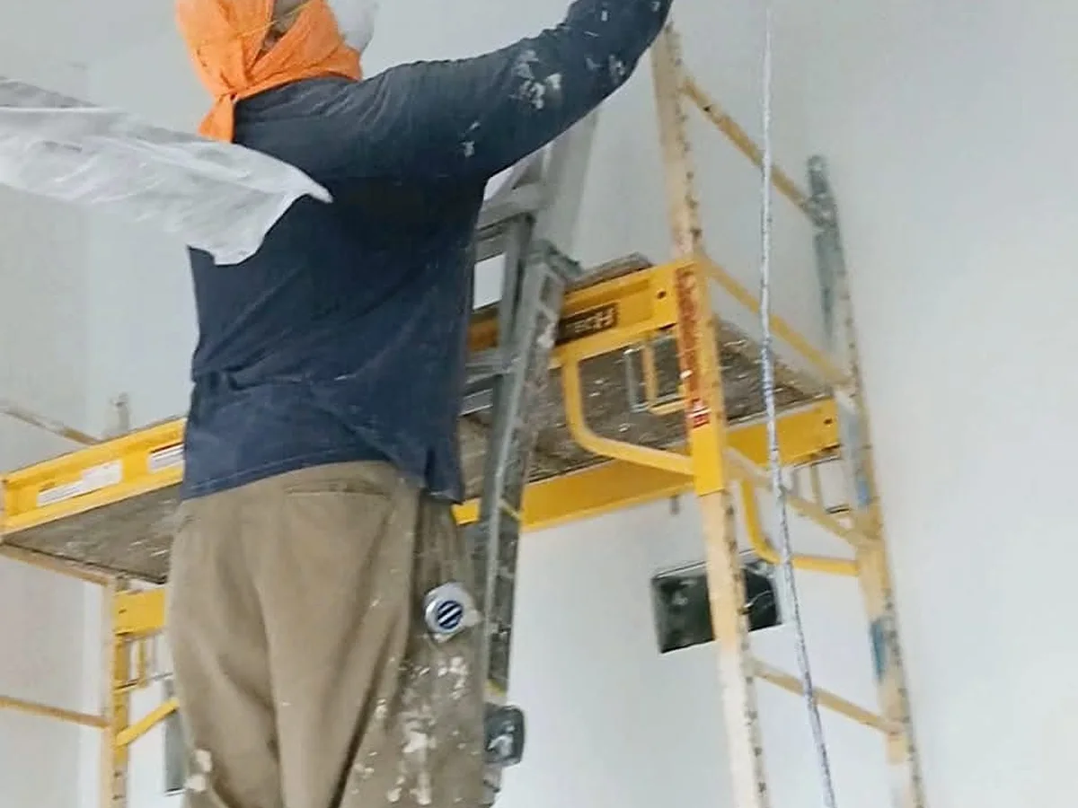 Painting a high ceiling from a scaffold