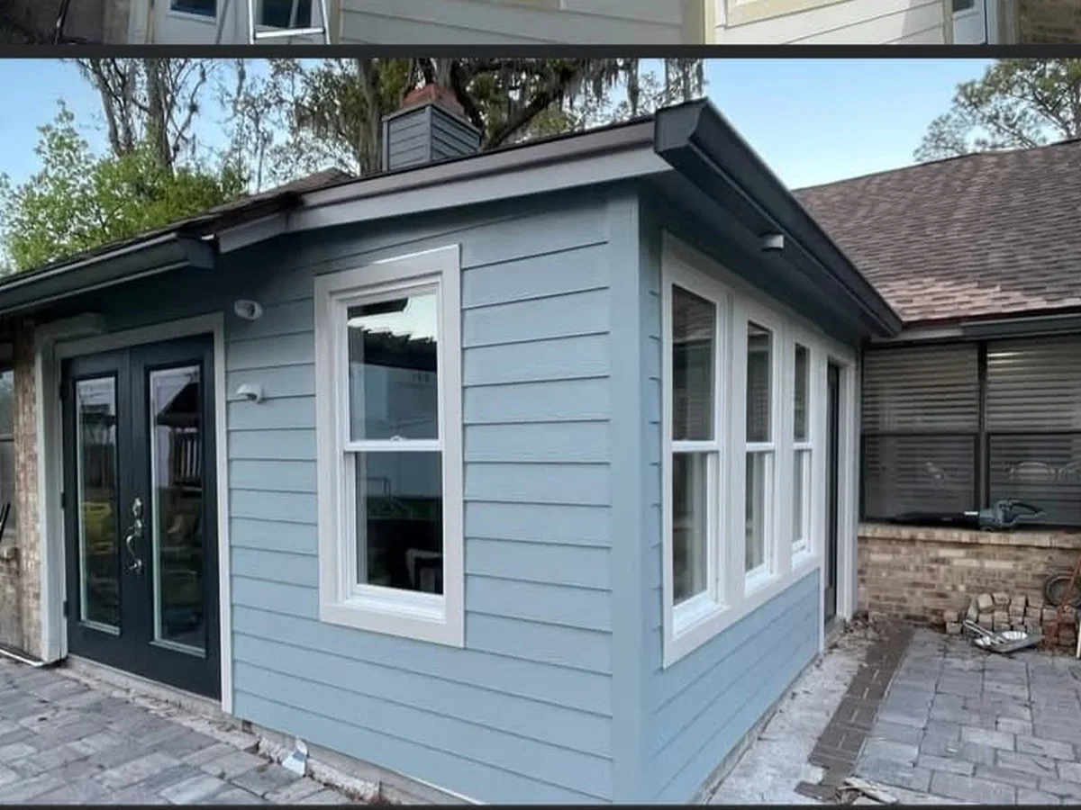 House exterior finished in grey-blue with white trim