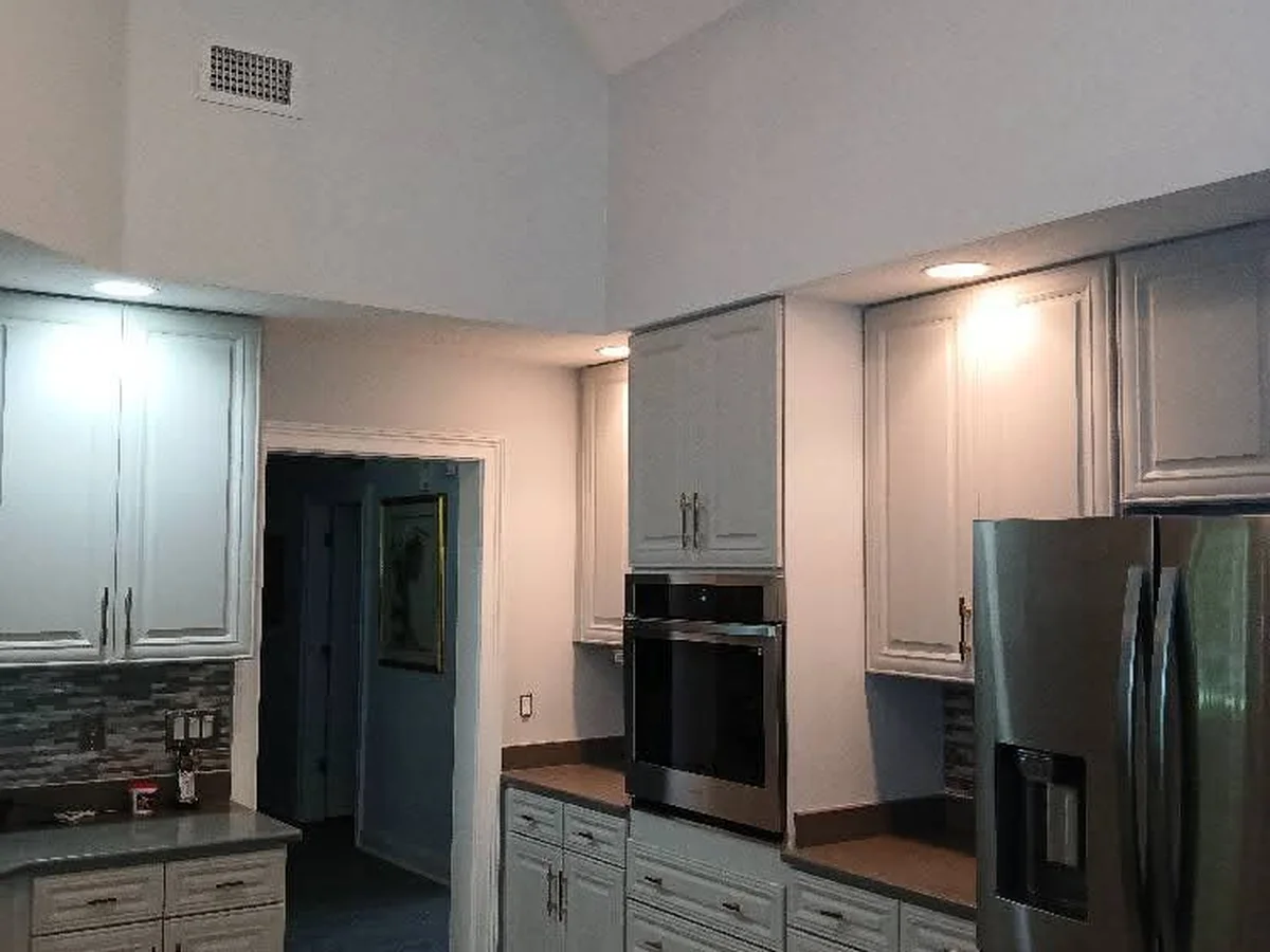 Kitchen with freshly painted white cabinets and walls